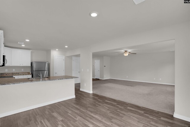313 Greenwood Valley Ct, Elgin, SC 29045 - kitchen with freestanding refrigerator, a sink, recessed lighting, light stone countertops, and baseboards