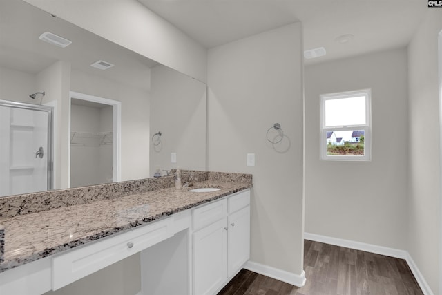 313 Greenwood Valley Ct, Elgin, SC 29045 - bathroom featuring a shower stall, vanity, a spacious closet, wood finished floors, and baseboards