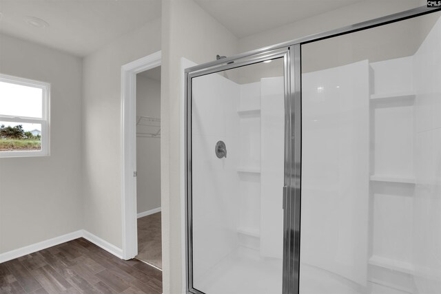 313 Greenwood Valley Ct, Elgin, SC 29045 - bathroom featuring a shower stall, wood finished floors, a walk in closet, and baseboards