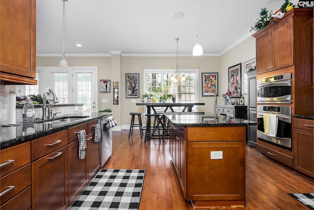 237 Peninsula Way, Columbia, SC 29229 - kitchen featuring a sink, stainless steel appliances, dark wood-type flooring, dark stone countertops, and ornamental molding