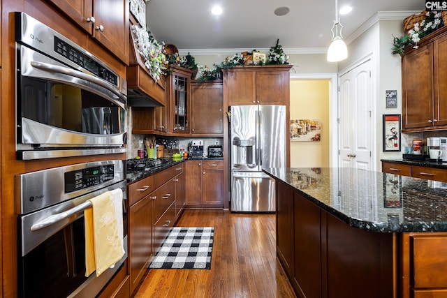 237 Peninsula Way, Columbia, SC 29229 - kitchen with appliances with stainless steel finishes, dark wood-style floors, backsplash, glass insert cabinets, and dark stone counters