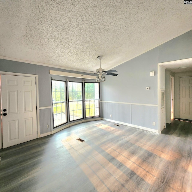 137 Breezy Bay Cir, Gilbert, SC 29054 - unfurnished living room with a textured ceiling, ceiling fan, wainscoting, lofted ceiling, and wood finished floors