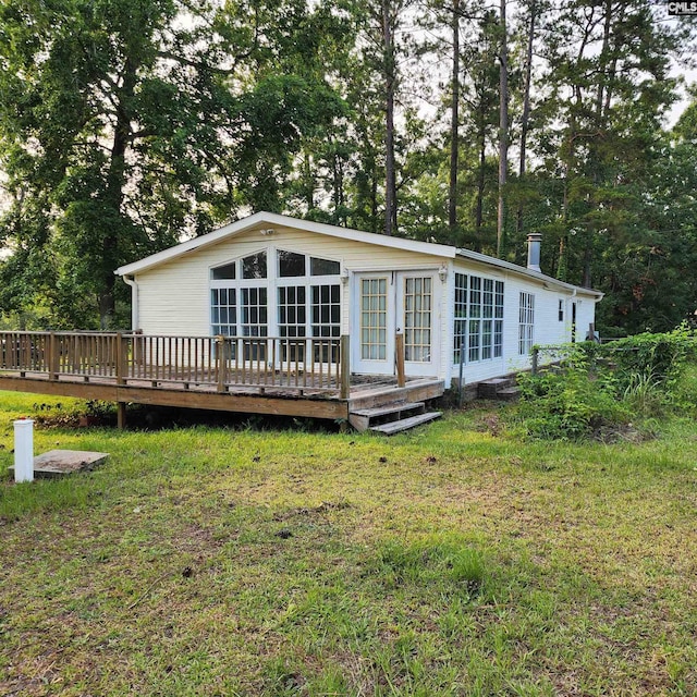 137 Breezy Bay Cir, Gilbert, SC 29054 - back of property with a deck and a lawn