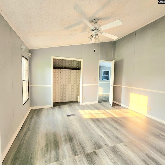 137 Breezy Bay Cir, Gilbert, SC 29054 - unfurnished bedroom featuring vaulted ceiling, a textured ceiling, wood finished floors, a closet, and a ceiling fan