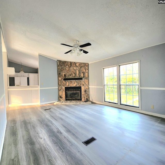 137 Breezy Bay Cir, Gilbert, SC 29054 - unfurnished living room featuring a textured ceiling, wood finished floors, baseboards, ceiling fan, and vaulted ceiling