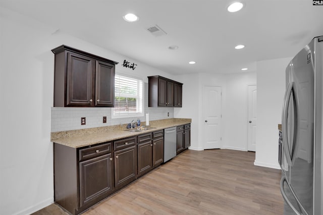 73 Mayapple Dr, Lexington, SC 29073 - kitchen with appliances with stainless steel finishes, dark brown cabinetry, a sink, recessed lighting, and backsplash