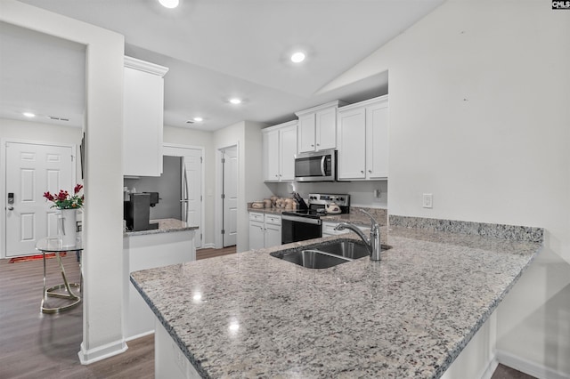 254 Sundew Rd, Elgin, SC 29045 - kitchen with appliances with stainless steel finishes, a peninsula, white cabinets, dark wood-style flooring, and a sink
