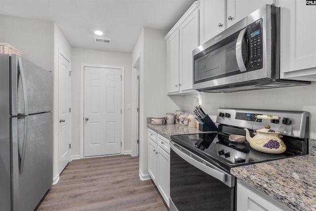 254 Sundew Rd, Elgin, SC 29045 - kitchen with appliances with stainless steel finishes, wood finished floors, white cabinetry, light stone counters, and recessed lighting