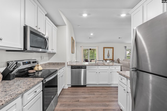 254 Sundew Rd, Elgin, SC 29045 - kitchen featuring stainless steel appliances, wood finished floors, white cabinetry, a peninsula, and recessed lighting