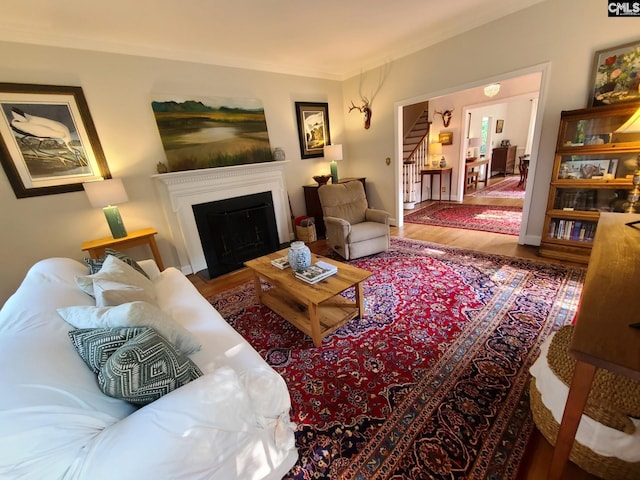 2003 Springdale Dr, Camden, SC 29020 - living area with stairs, ornamental molding, a fireplace with flush hearth, and wood finished floors