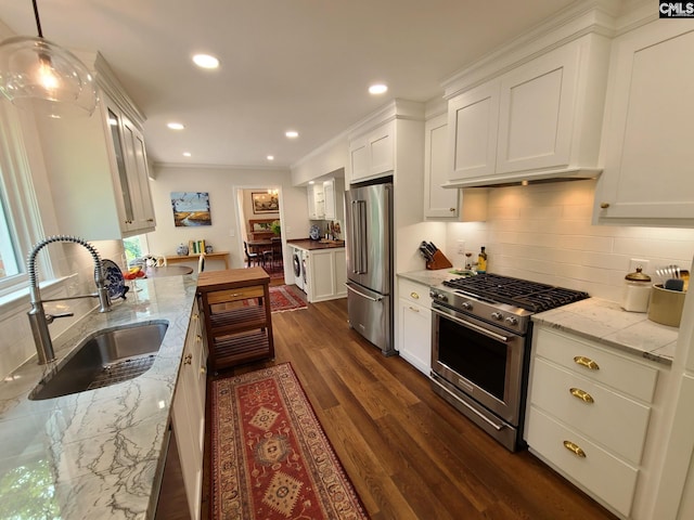 2003 Springdale Dr, Camden, SC 29020 - kitchen featuring stainless steel appliances, a sink, dark wood finished floors, washer / clothes dryer, and white cabinets
