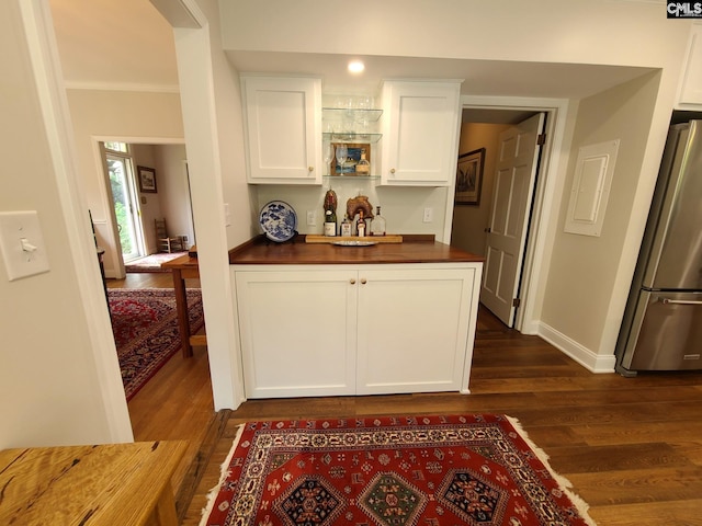2003 Springdale Dr, Camden, SC 29020 - kitchen featuring freestanding refrigerator, dark wood-style floors, white cabinets, baseboards, and crown molding