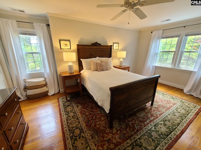 2003 Springdale Dr, Camden, SC 29020 - bedroom with light wood finished floors, crown molding, ceiling fan, and baseboards