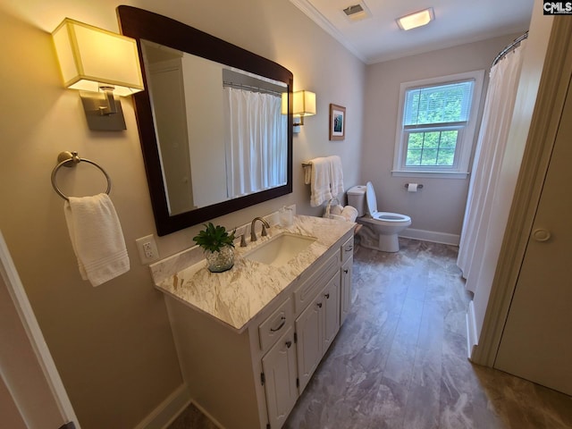 2003 Springdale Dr, Camden, SC 29020 - bathroom with ornamental molding, vanity, toilet, baseboards, and wood finished floors