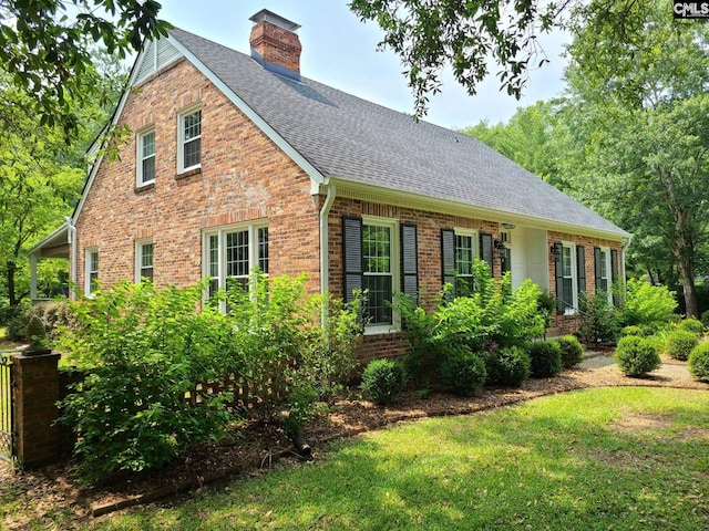 2003 Springdale Dr, Camden, SC 29020 - view of front of home with a shingled roof, brick siding, a chimney, and a front yard