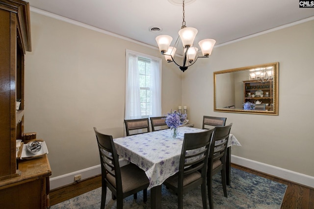 4524 Mosshill Rd, Columbia, SC 29206 - dining space featuring a chandelier, baseboards, crown molding, and wood finished floors
