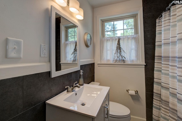 4524 Mosshill Rd, Columbia, SC 29206 - full bathroom featuring vanity, tile walls, plenty of natural light, toilet, and a shower with curtain