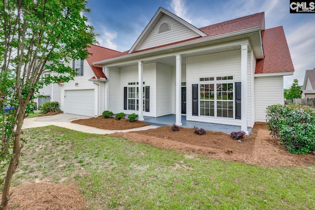 612 Bur Oak Ln, Columbia, SC 29229 - view of front of house with driveway, covered porch, a front yard, roof with shingles, and a garage
