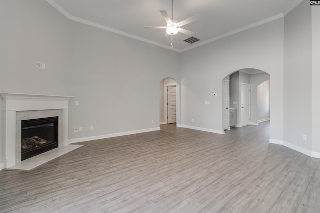 2752 Pawtucket Way, Chapin, SC 29036 - unfurnished living room featuring a ceiling fan, arched walkways, ornamental molding, light wood-type flooring, and baseboards