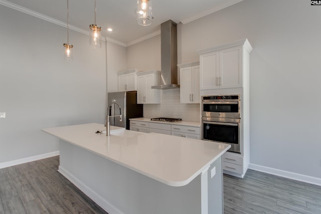 2752 Pawtucket Way, Chapin, SC 29036 - kitchen featuring appliances with stainless steel finishes, wall chimney exhaust hood, a sink, an island with sink, and tasteful backsplash