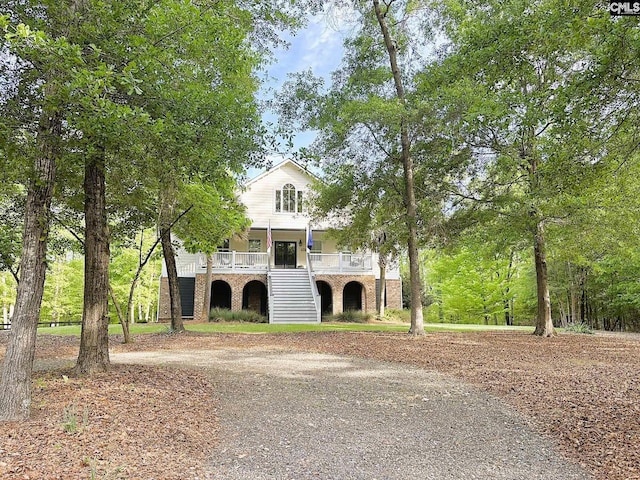 166 Sawney Creek Cir, Ridgeway, SC 29130 - raised beach house with stairway, driveway, brick siding, and a porch