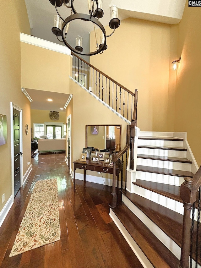166 Sawney Creek Cir, Ridgeway, SC 29130 - staircase featuring a chandelier, hardwood / wood-style floors, baseboards, a towering ceiling, and crown molding