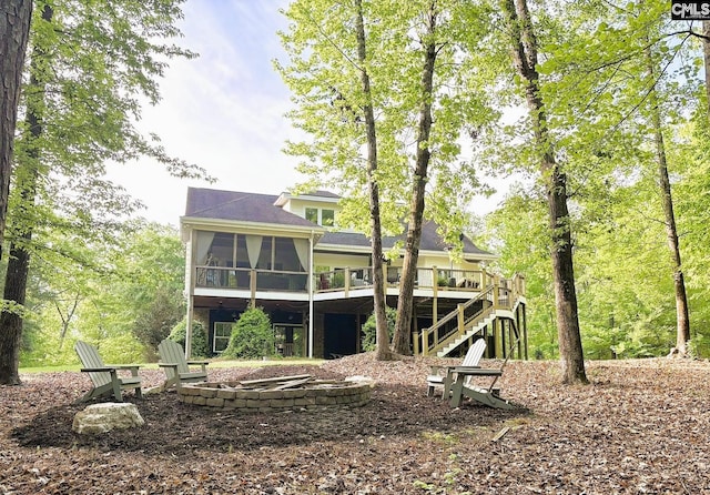 166 Sawney Creek Cir, Ridgeway, SC 29130 - rear view of property featuring an outdoor fire pit, a sunroom, stairway, and a wooden deck
