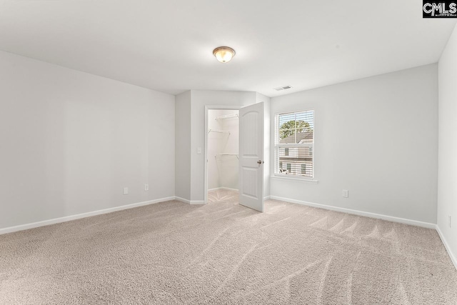 337 Gum Swamp Trl, West Columbia, SC 29169 - unfurnished bedroom featuring baseboards, light carpet, a spacious closet, and a closet