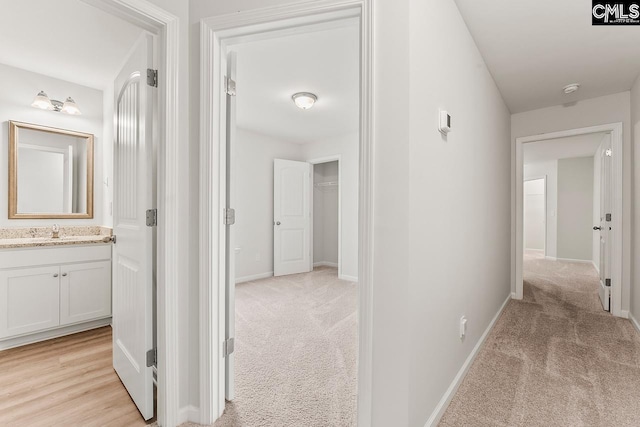 339 Gum Swamp Trl, West Columbia, SC 29169 - hall with light colored carpet, a sink, and baseboards