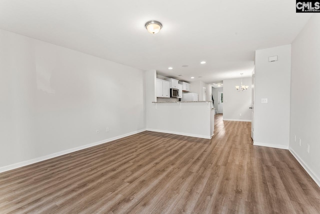339 Gum Swamp Trl, West Columbia, SC 29169 - unfurnished living room featuring a chandelier, light wood-style floors, baseboards, and recessed lighting