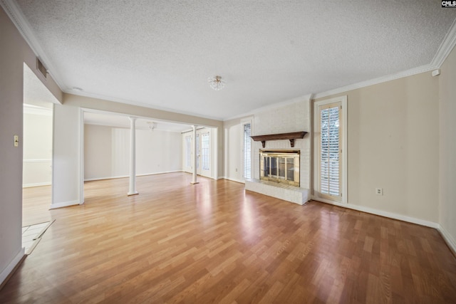 137 Shannondale Ct, Columbia, SC 29209 - unfurnished living room featuring crown molding, a textured ceiling, wood finished floors, baseboards, and a brick fireplace