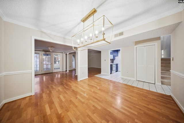 137 Shannondale Ct, Columbia, SC 29209 - unfurnished living room featuring a textured ceiling, stairway, light wood-style flooring, ornamental molding, and baseboards