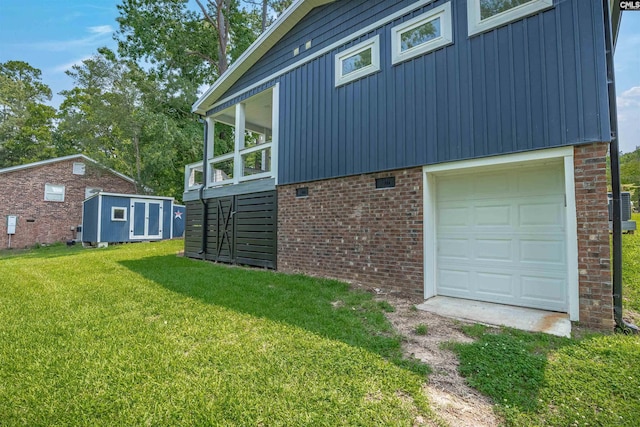 1620 Deep Cove Ln, Gilbert, SC 29054 - view of home's exterior featuring board and batten siding, a yard, a garage, brick siding, and a storage shed