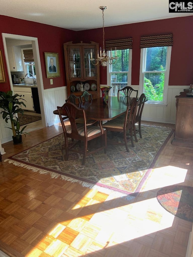 325 Pond View Ln, Lexington, SC 29072 - dining space featuring a wainscoted wall and a chandelier