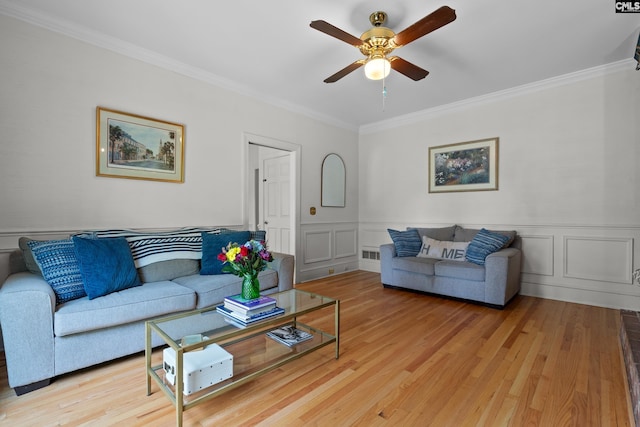 22 Mallet Hill Ct, Columbia, SC 29223 - living area featuring crown molding, a ceiling fan, light wood finished floors, wainscoting, and a decorative wall