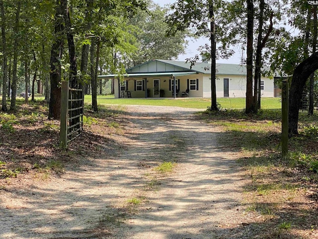 290 Gunter Pond Rd, Wagener, SC 29164 - view of front of home featuring dirt driveway, a porch, board and batten siding, and a carport