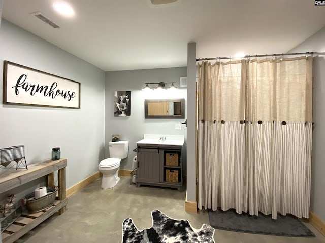 290 Gunter Pond Rd, Wagener, SC 29164 - bathroom with toilet, baseboards, vanity, and concrete floors