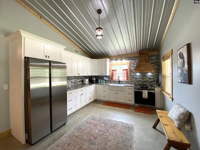 290 Gunter Pond Rd, Wagener, SC 29164 - kitchen with appliances with stainless steel finishes, concrete flooring, lofted ceiling, tasteful backsplash, and a sink