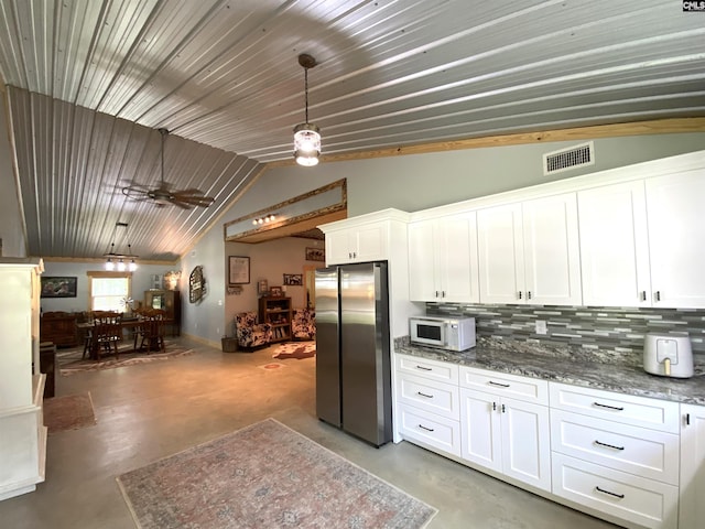 290 Gunter Pond Rd, Wagener, SC 29164 - kitchen featuring freestanding refrigerator, finished concrete floors, white microwave, white cabinets, and decorative backsplash