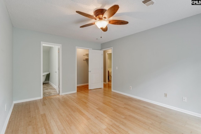 201 Mariners Row, Columbia, SC 29212 - unfurnished bedroom with a spacious closet, light wood finished floors, a closet, and baseboards