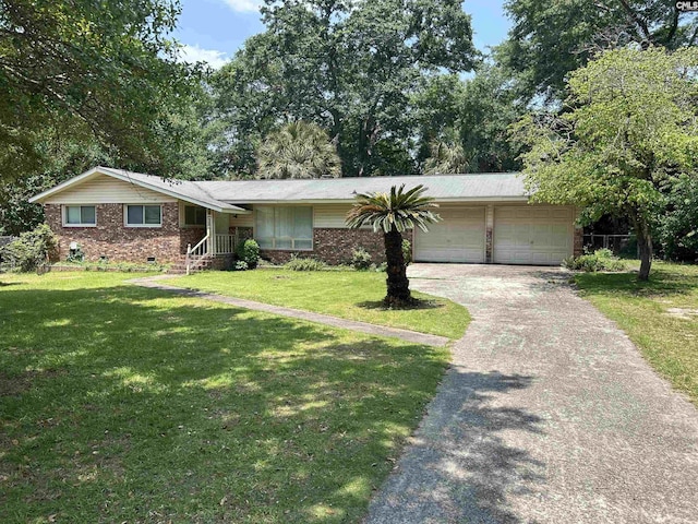 1147 Gunter Cir, West Columbia, SC 29169 - view of front of house featuring an attached garage, asphalt driveway, a front yard, and brick siding