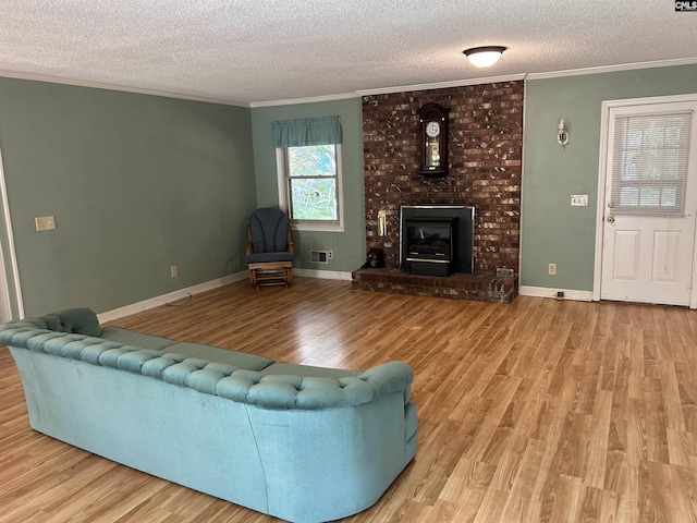 1147 Gunter Cir, West Columbia, SC 29169 - living room with a textured ceiling, wood finished floors, ornamental molding, a fireplace, and baseboards