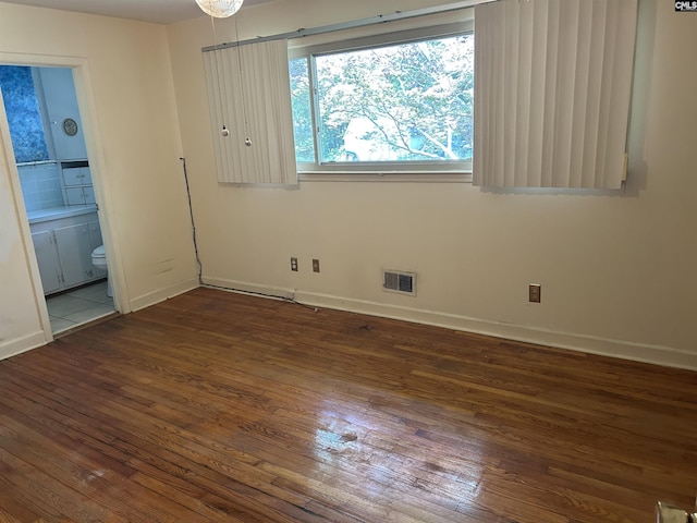 1147 Gunter Cir, West Columbia, SC 29169 - unfurnished bedroom featuring wood-type flooring, baseboards, and connected bathroom
