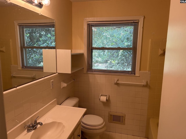 1147 Gunter Cir, West Columbia, SC 29169 - bathroom with tile walls, toilet, vanity, and tub / shower combination