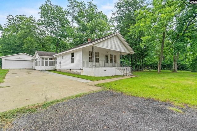 114 Quattlebaum Ave, Ridge Spring, SC 29129 - view of front of house with covered porch, crawl space, a front lawn, a detached garage, and an outdoor structure