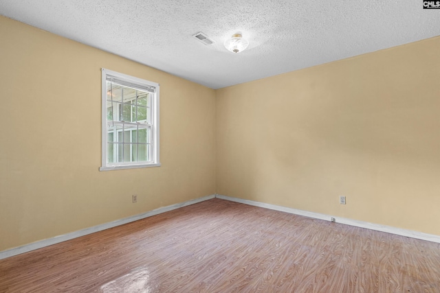 114 Quattlebaum Ave, Ridge Spring, SC 29129 - unfurnished room with wood finished floors, baseboards, and a textured ceiling