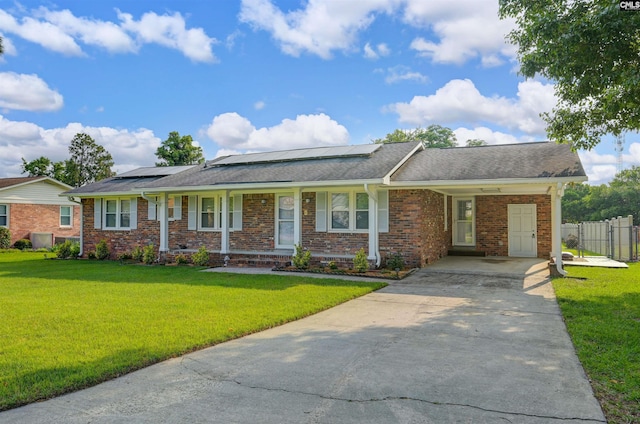 1129 Starcrest Dr, West Columbia, SC 29172 - single story home with driveway, a porch, brick siding, solar panels, and a shingled roof