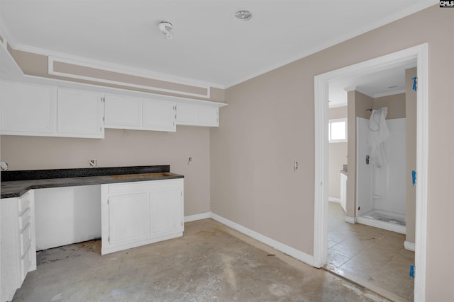 4712 Leaf Crest Ct, Columbia, SC 29210 - kitchen with white cabinetry, ornamental molding, dark countertops, baseboards, and unfinished concrete floors