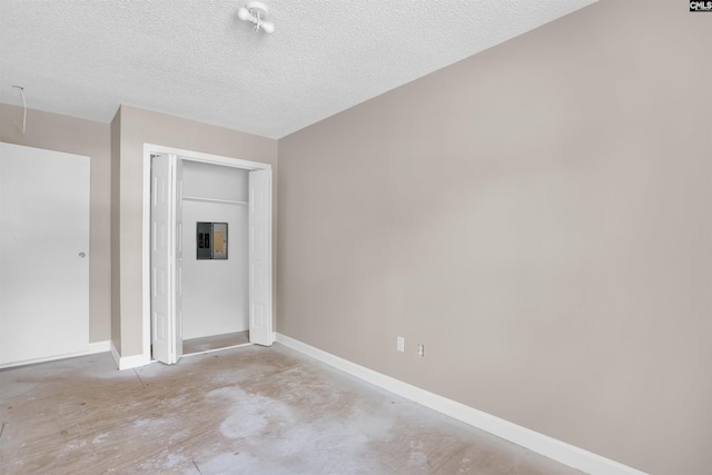 4712 Leaf Crest Ct, Columbia, SC 29210 - unfurnished bedroom featuring baseboards, a closet, unfinished concrete flooring, electric panel, and a textured ceiling