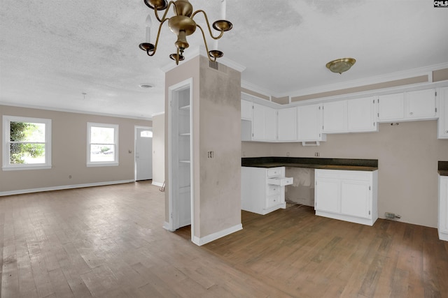 4712 Leaf Crest Ct, Columbia, SC 29210 - kitchen featuring crown molding, dark wood-style flooring, open floor plan, dark countertops, and white cabinets